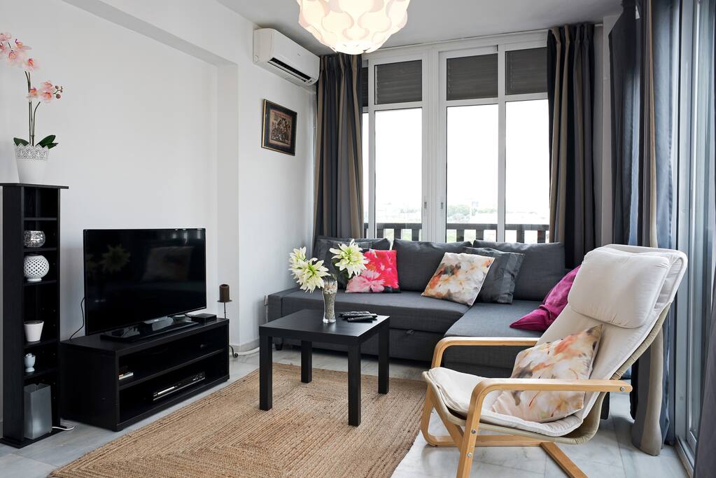 Bright beautiful living room with plenty of windows. WiFi and air conditioning in all rooms.