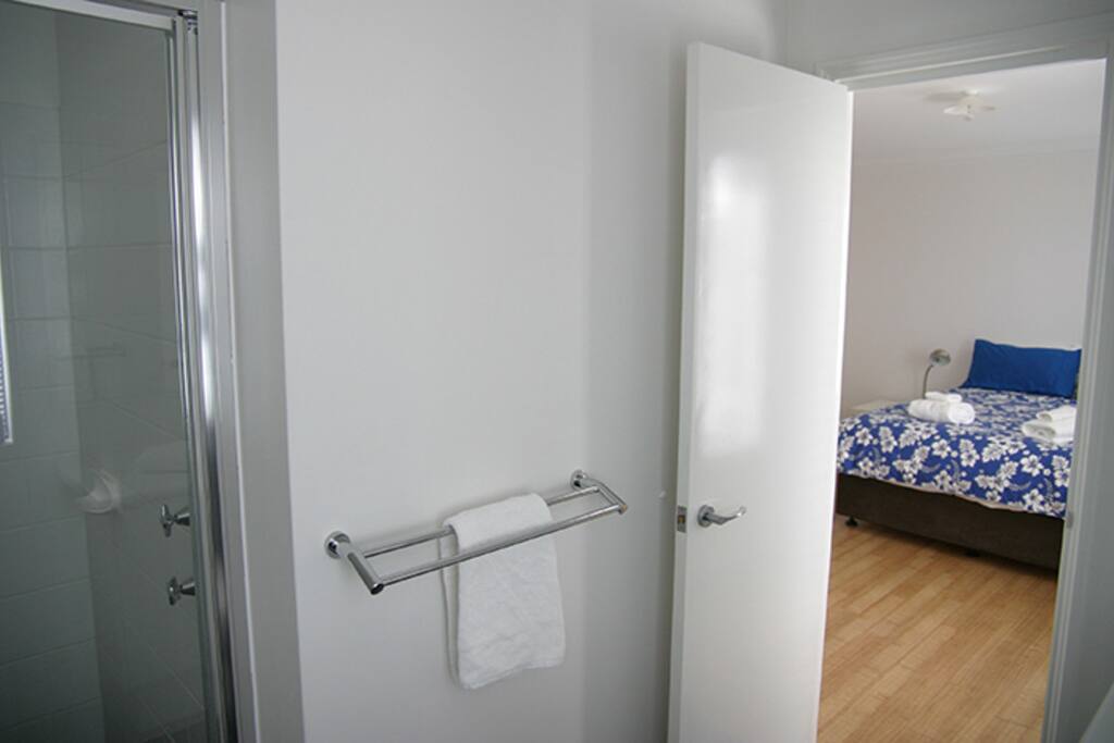 Main bedroom from the ensuite (the colourful doona covers are charged regularly!)