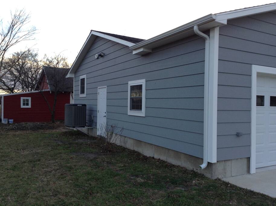 East side of house. Door entrance to the garage.
