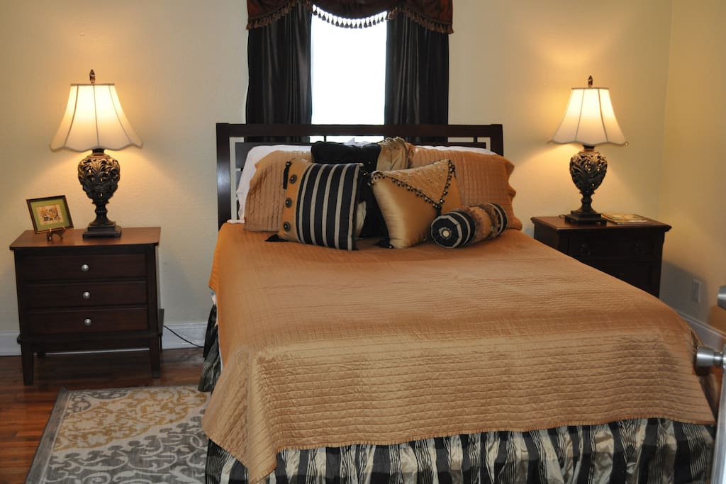 Very comfortable queen sized bed with side tables and a dresser for storage.