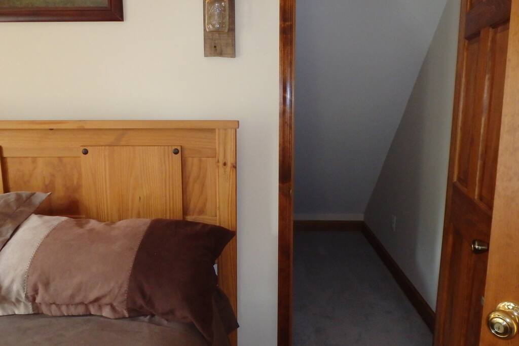 This door to the right of the bed goes into the small room.