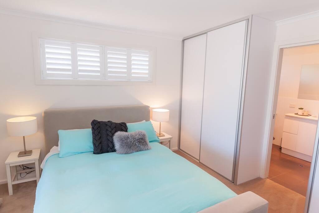 Master bedroom with flat screen TV and ensuite
