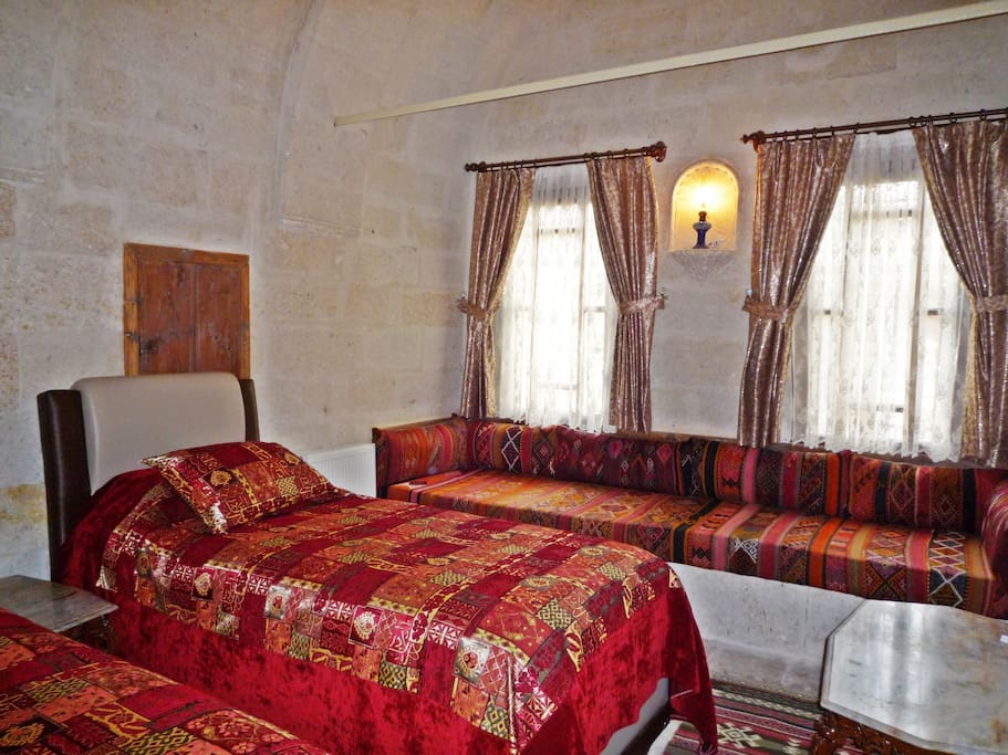 Seljuk Suite second bedroom with twin beds and traditional seating that can become another bed.