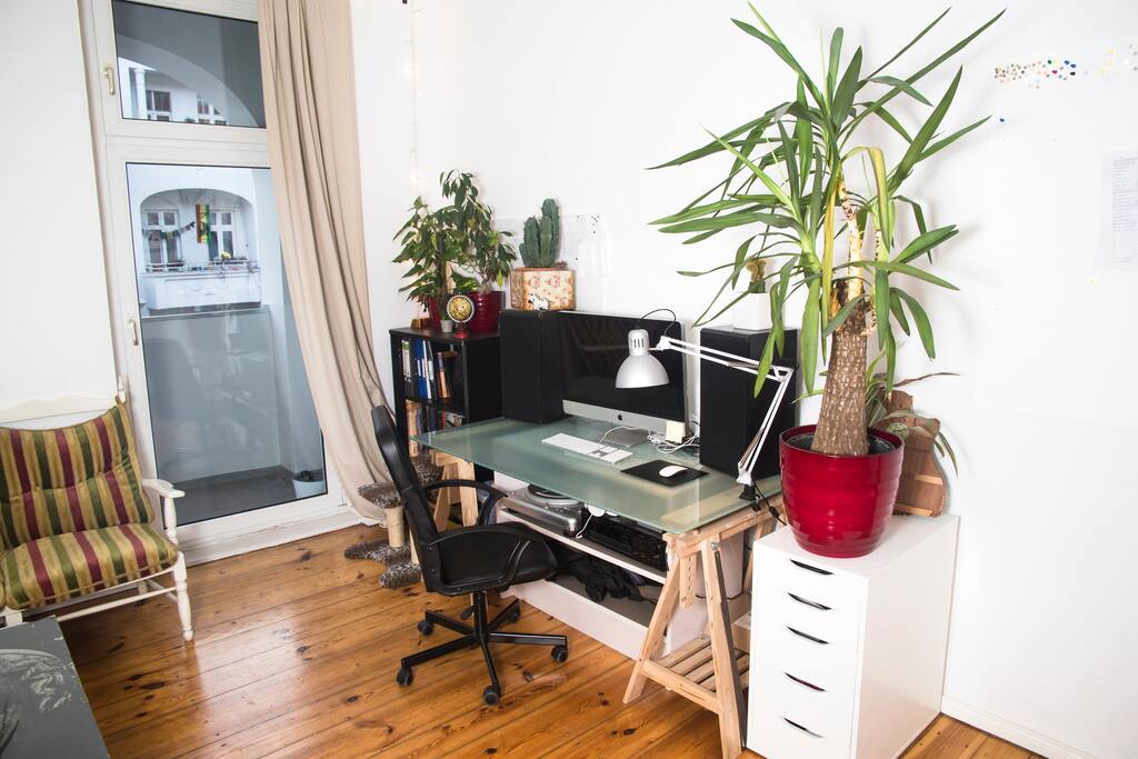 The window door leads to a balcony. Glass table suitable a laptop for example