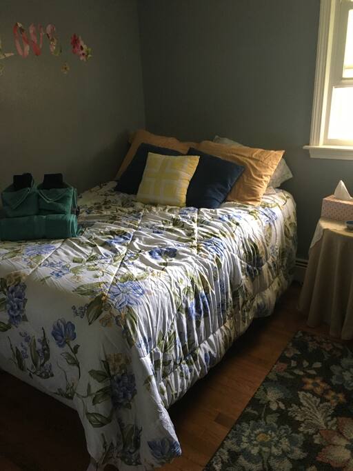 Sunny and cozy bedroom with full sized pillow top bed.