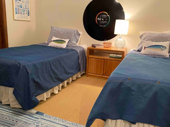 One of two bedrooms on the main floor with two twin beds, a closet and dresser. 