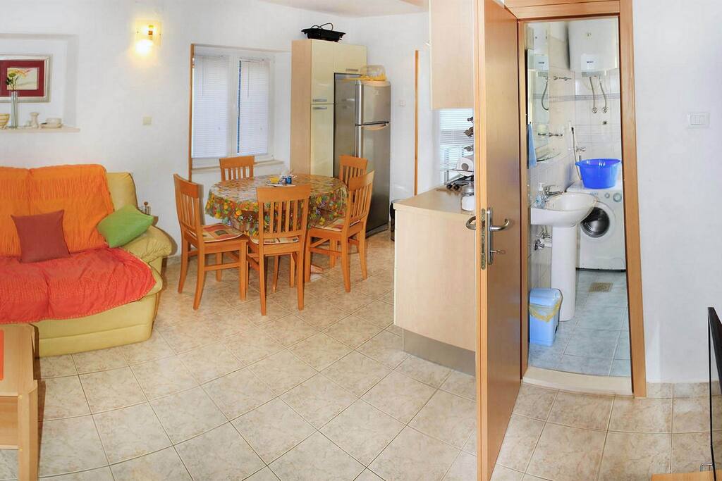 A view of the living room, sitting area and the kitchen
