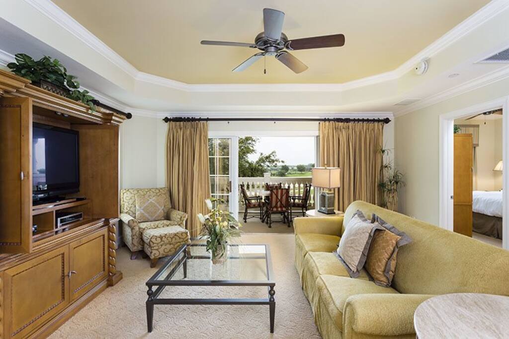 Be surrounded by pure luxury in this beautiful living room offering views of the golf course