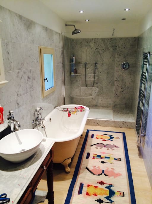 marble bathroom with bath and shower