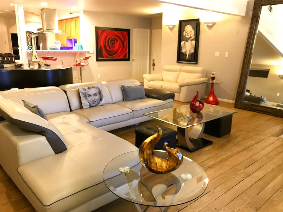 Modern living room with surround sound, tv, PS4 and comfortable spacious area.