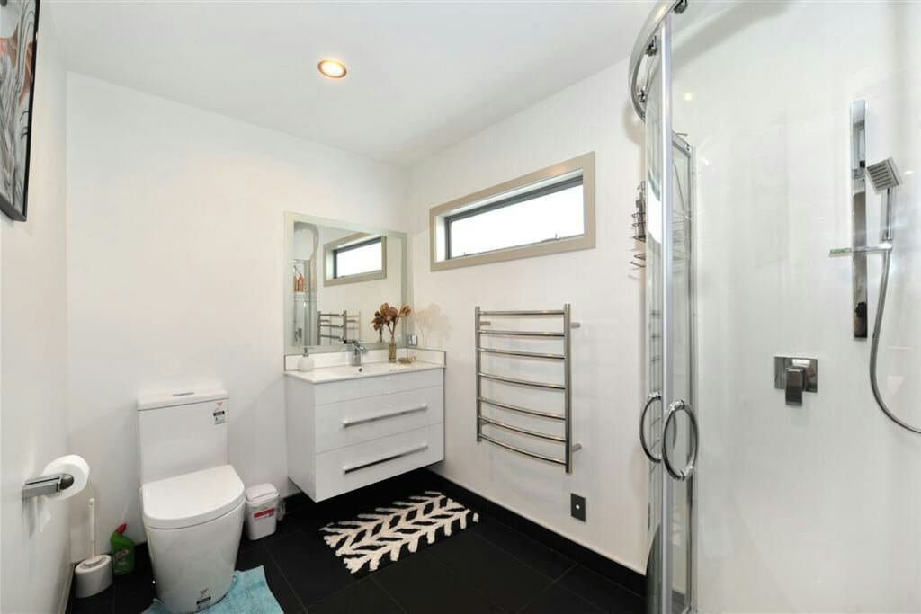The brand new shower is located upstairs in the master bedroom with shower, toilet, vanity, heated towel rail and bathroom fan heater