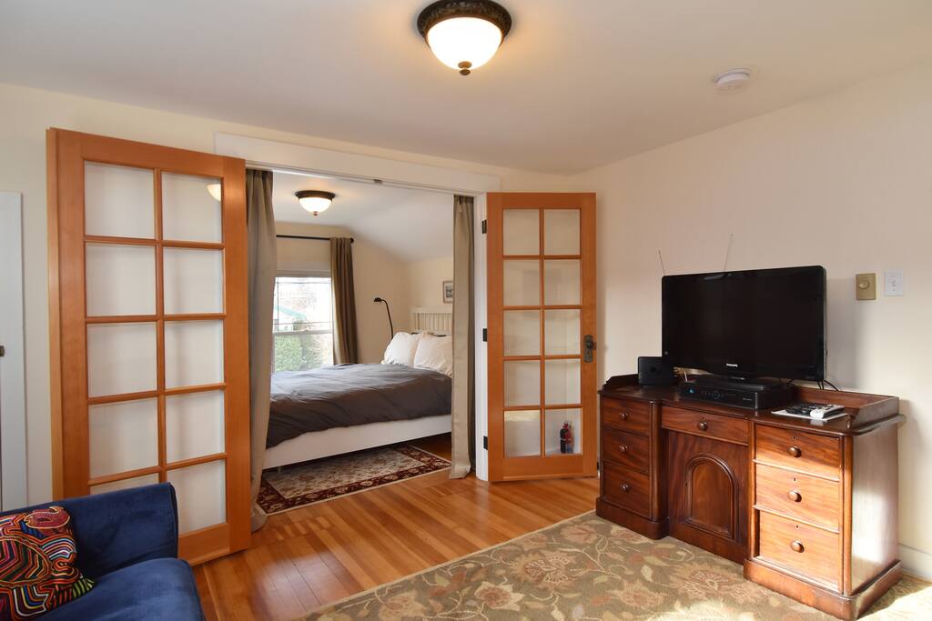 Living room with hi def cable, high speed wireless internet and french doors to the second bedroom