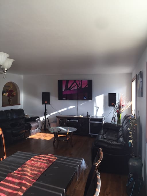 Living room with 70' TV and reclining sofa and love seats