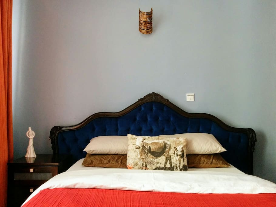 The bed is an antique with a comfortable queen sized. mattress