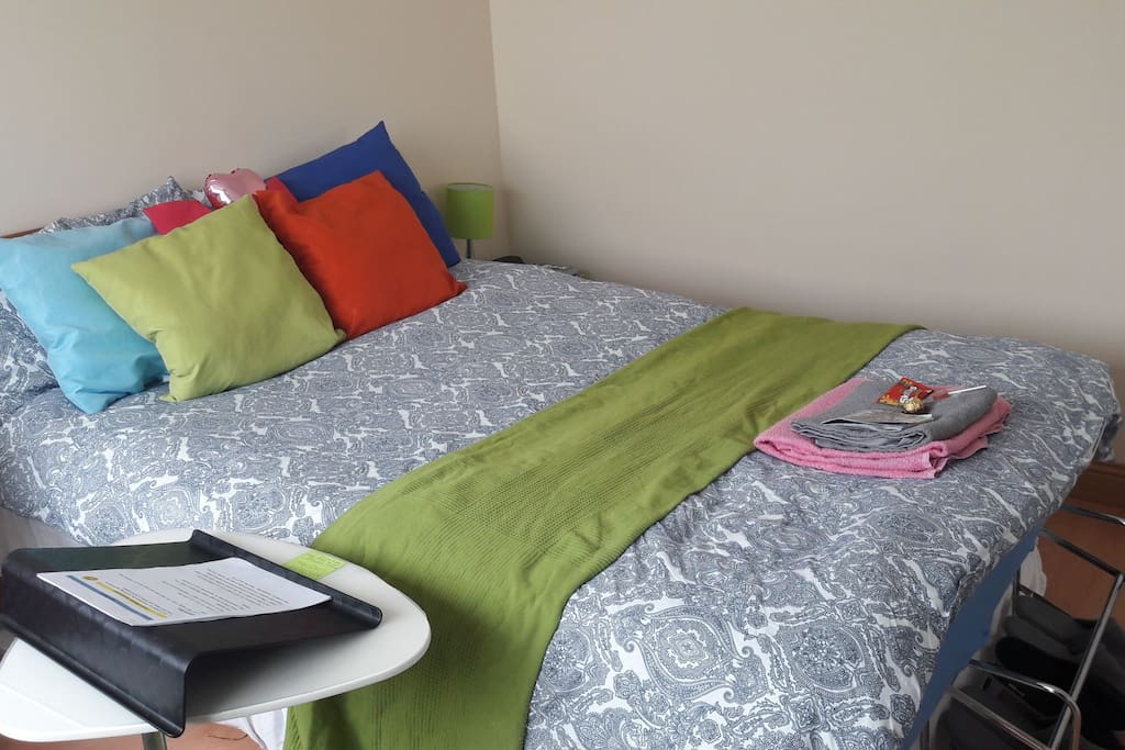 Large comfortable queen size bed + laptop stand with a laptop support.