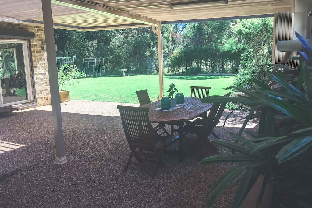 covered bbq area looking out towards back yard/garden area
