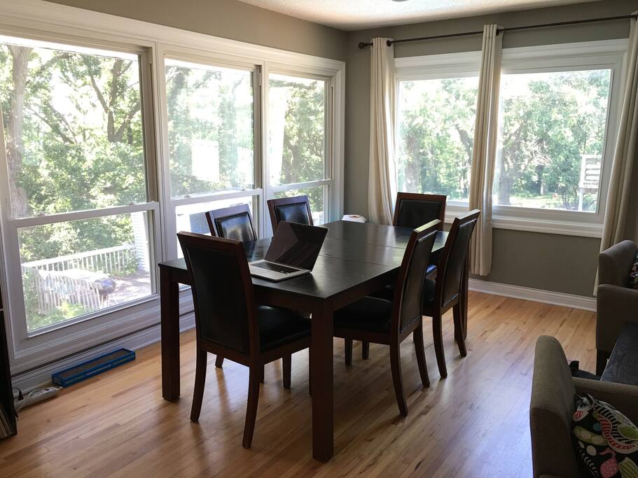 Open dining area overlooking backyard and forest.