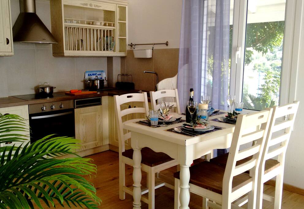 Inside dining area and fully fitted kitchen (including dishwasher) with fridge/freezer, electric oven and four ring hob.