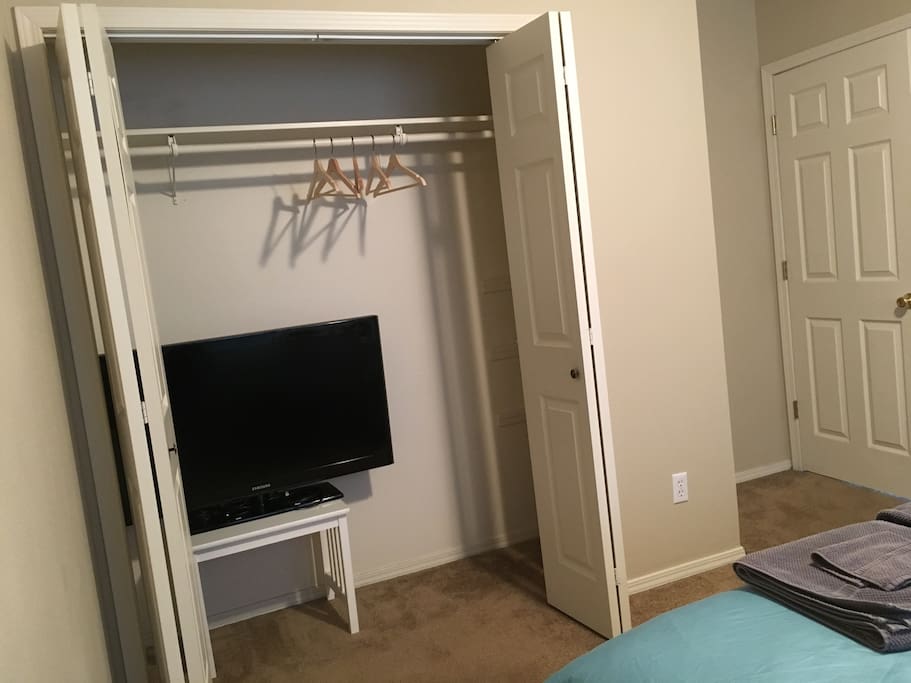 The TV can be hooked up to a computer via HDMI cable. Shelves are on the right side of the closet.