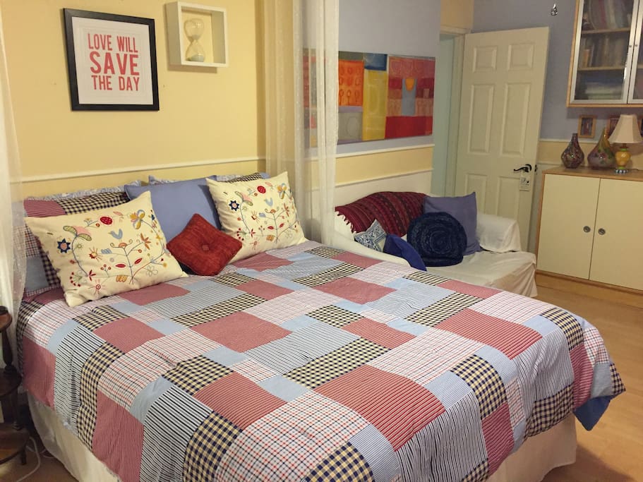 Comfy, queen size bed and loveseat in the room give guests spaces to curl up in!