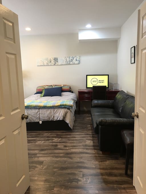 Inside the spacious studio, you will see a nice leather couch to lounge and a desk with TV.