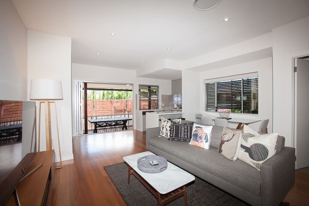 open plan lounge leading to large entertainment deck