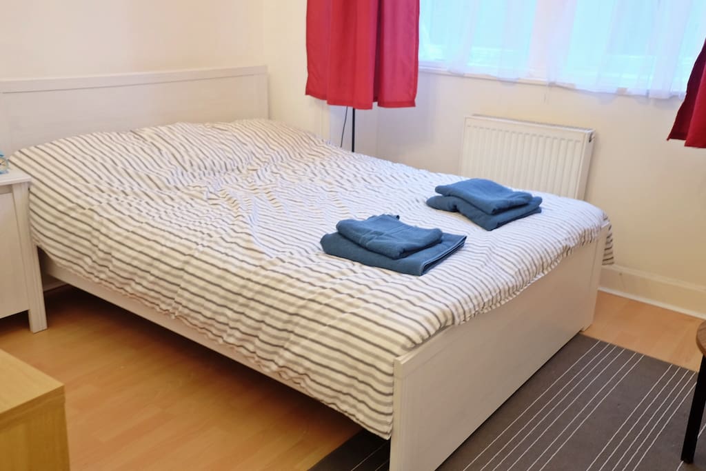 Double bed in bedroom 1 and bedside table
