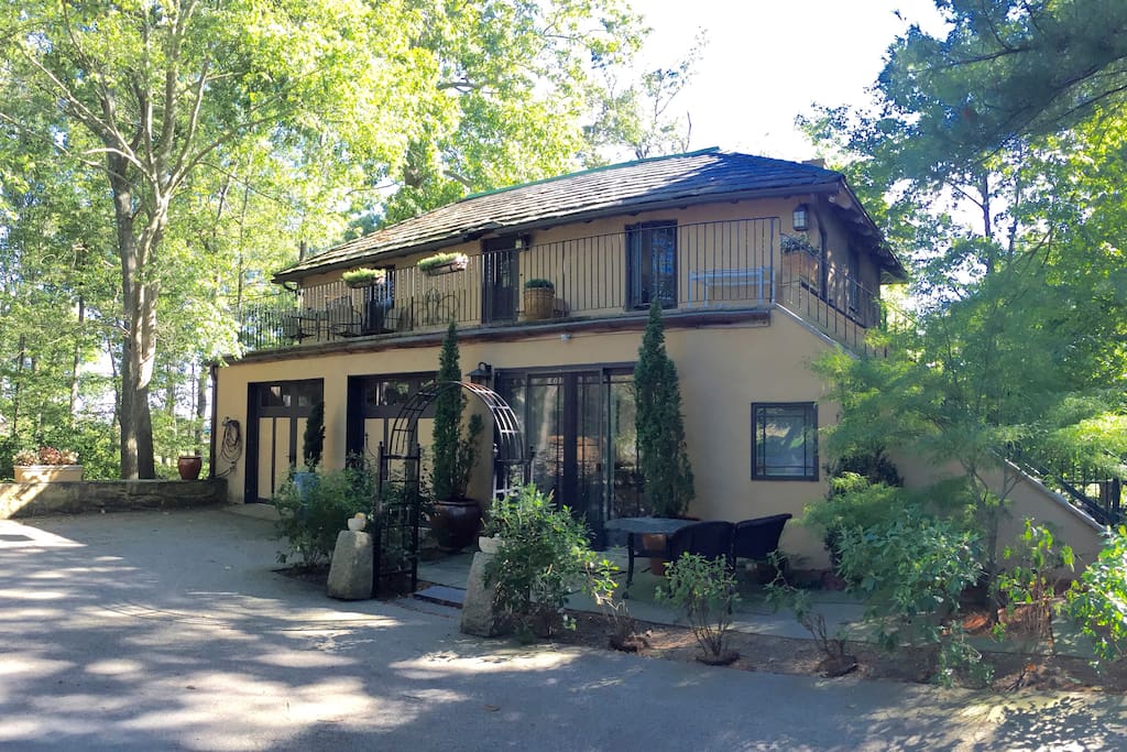 The carriage house, with the pied-a-terre at the top of the stairs. You have your own private patio with a view of the pond.