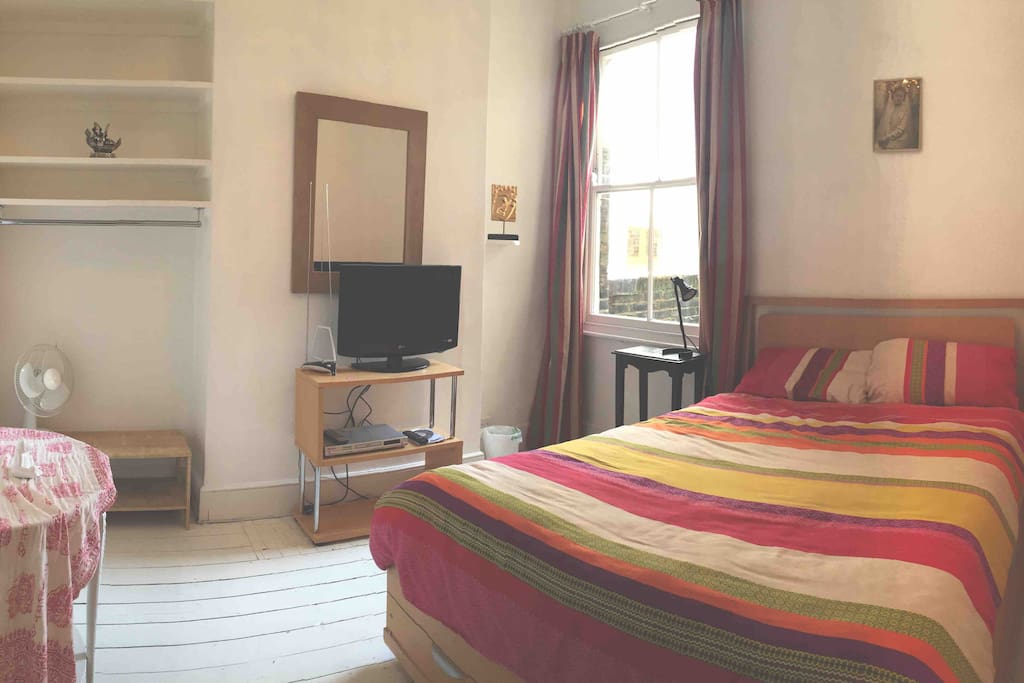 Master bedroom with double bed and TV/DVD player. Drawers under the bed hold spare bedding/towels.