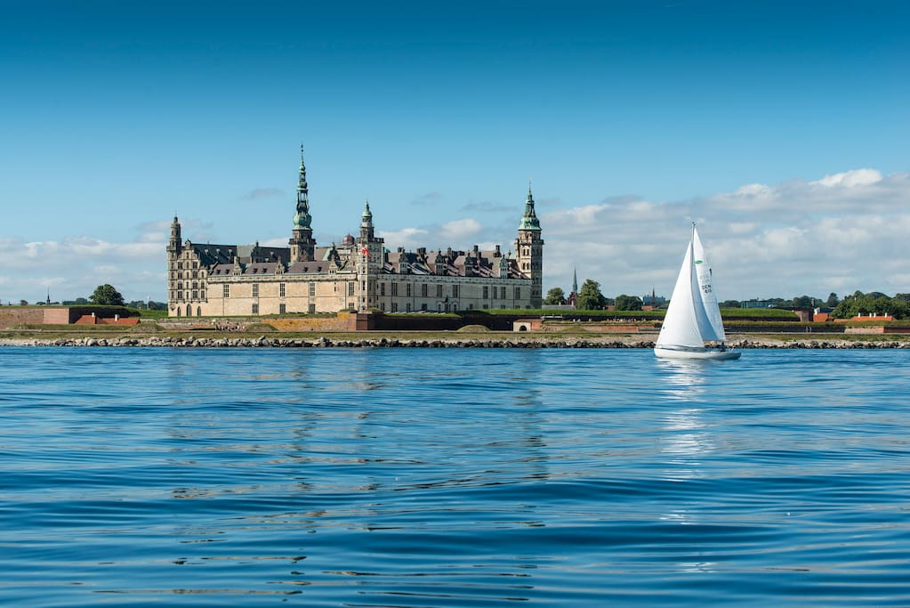 Kronborg Castle towers above a very narrow promontory between the coasts of Denmark and Sweden.