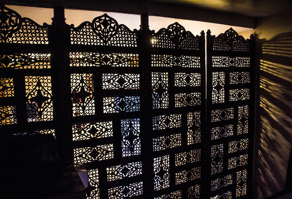 Inspired by Mughal Styles the bed Area in the room is seperated from the room by an ornate Kashmiri Handcrafted Wooden Partition