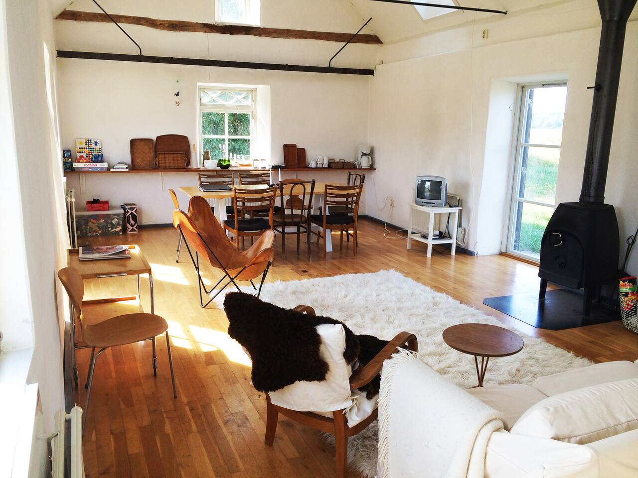 Living room with plenty of natural light and cast iron stove