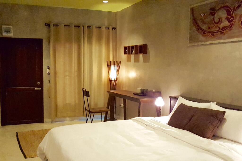King-sized bed with duvet and pillows.