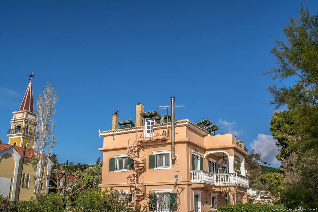 Eastern side of the house with the bell tower of the Orthodox church of Agios Efstathios
