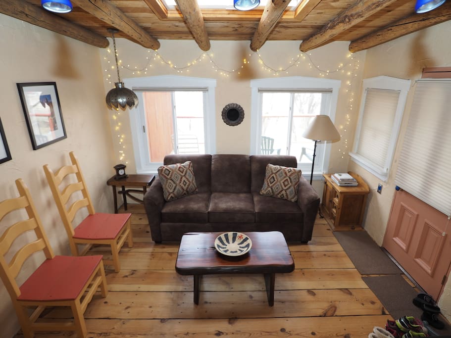 Living room with queen size memory foam sofa sleeper and TV room; lots of windows and sun