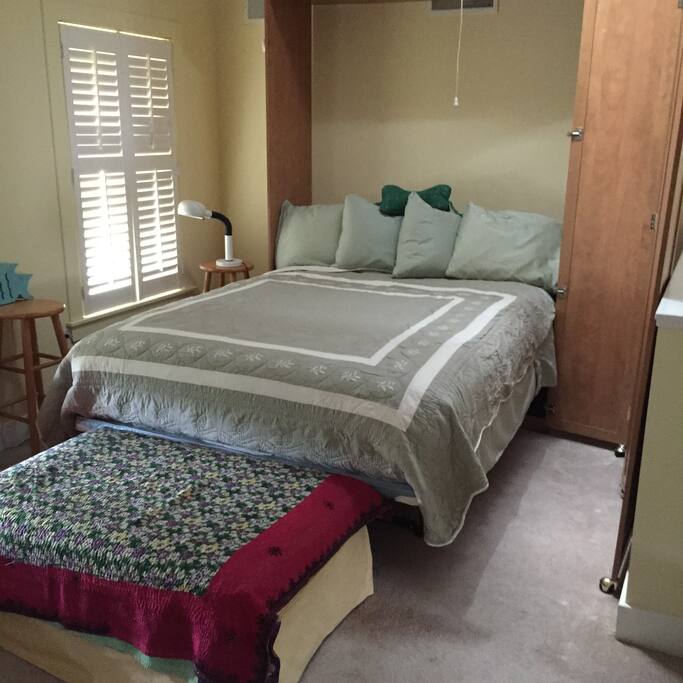 Sleeping nook in third floor loft with queen bed.