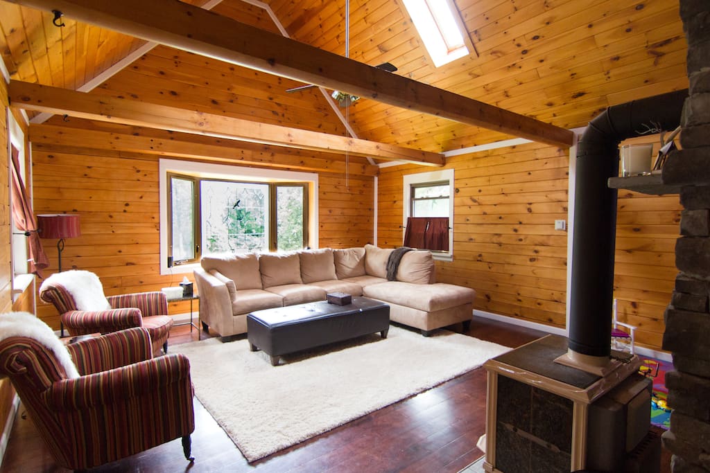 Living room with soapstone stove and vaulted ceilings