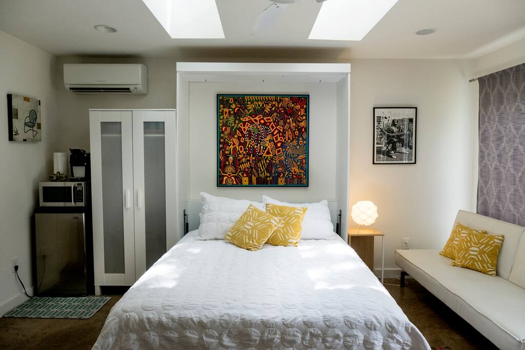 Queen size bed with linens, closet with suitcase stands and hangers for your clothes.