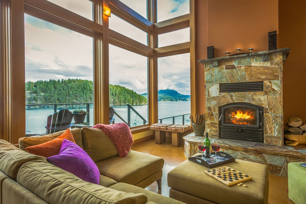 Warm wood burning fireplace with a spectacular waterfront view for cozy winter nights.