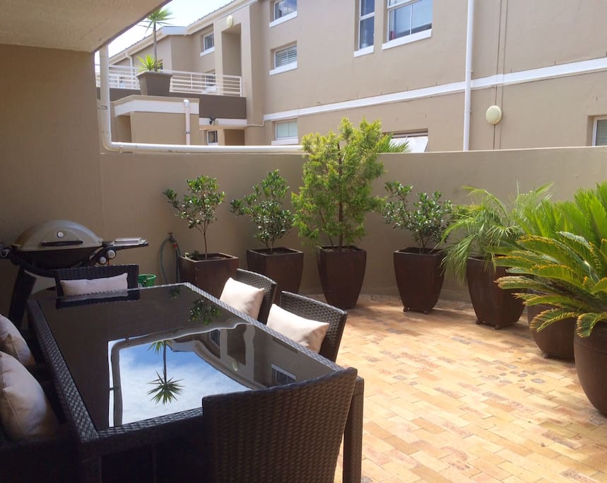 Private outdoor patio with gas barbecue and outdoor furniture