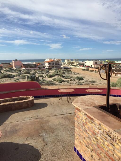 Terraced patios facing beach with fire pit