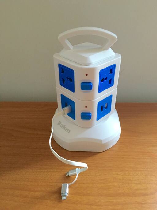 Desk surge protecter charging station with 6 outlets including USB ports with built in world adaptor. Smart phone charging chord provided for guest use!