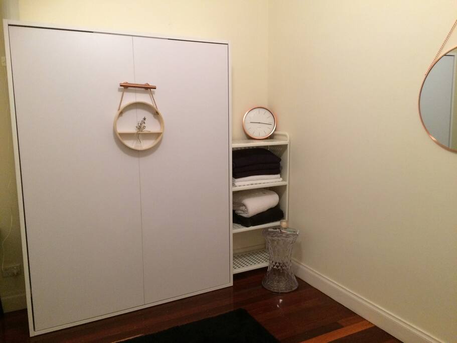 The upstairs private room with the closed wall bed.