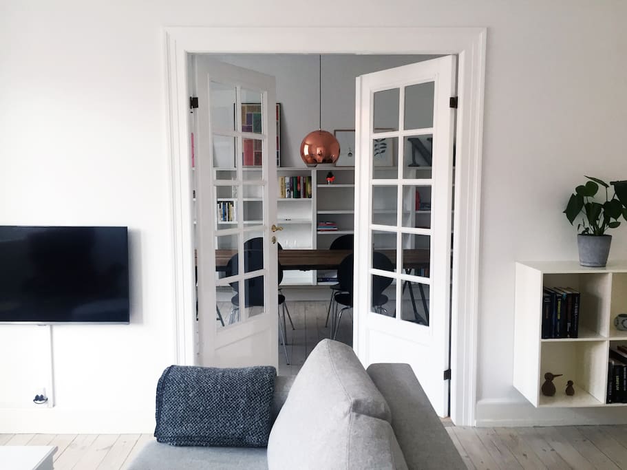 French doors seperate the living room and the dining room