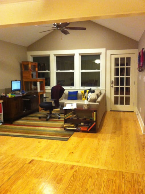 Family room with sofa bed. Back door leads to screened-in back porch.
