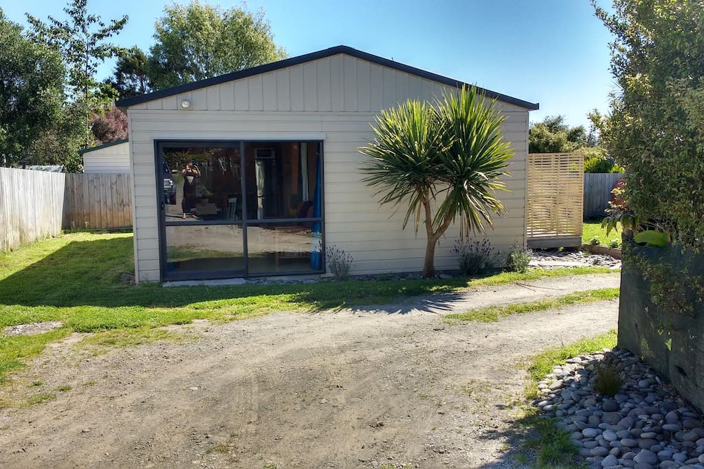 Studio from the side. Studio parking to left of this door. Shared Drive with Main House