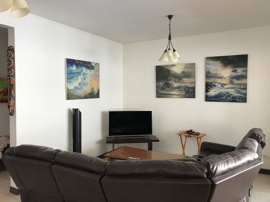 Open and very comfortable living space with flat screen TV and reclinable seating.