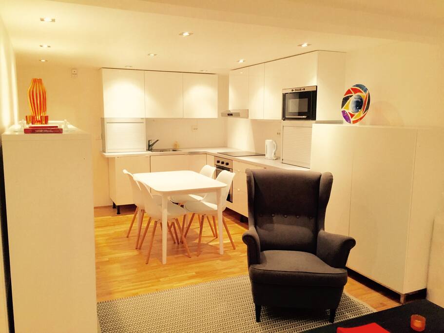 Kitchen area with dining table siting four people.
