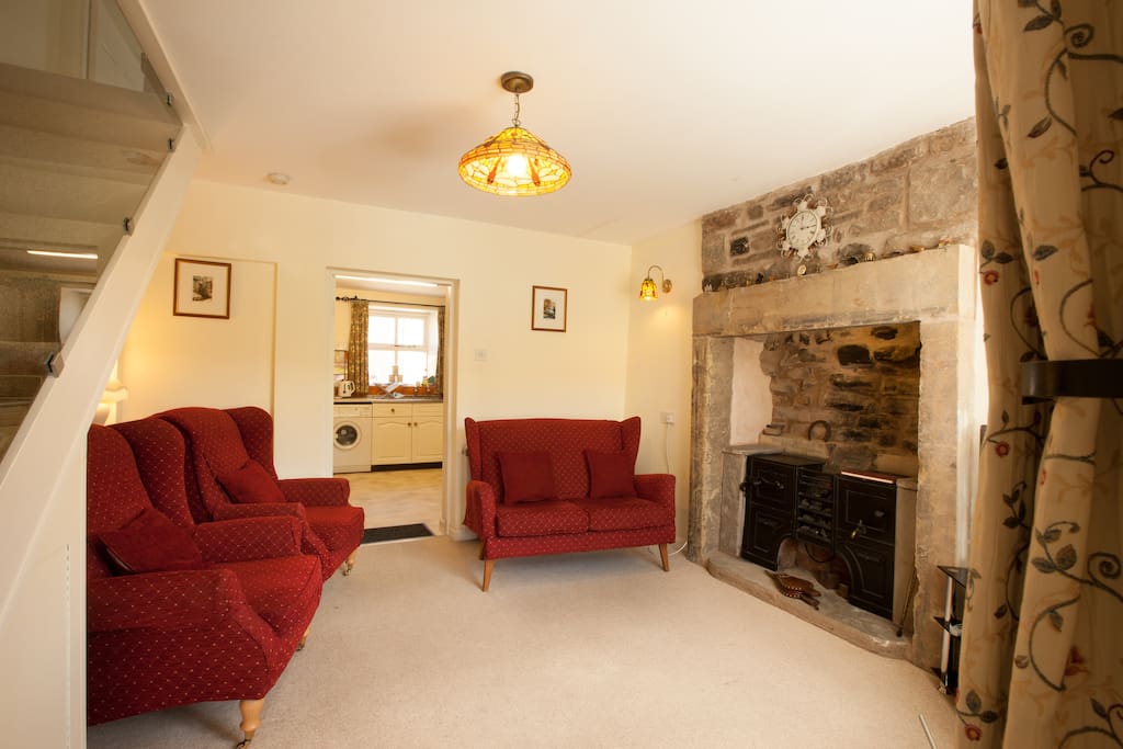 Cosy sitting room with traditional hearth and range with visual coal-effect.