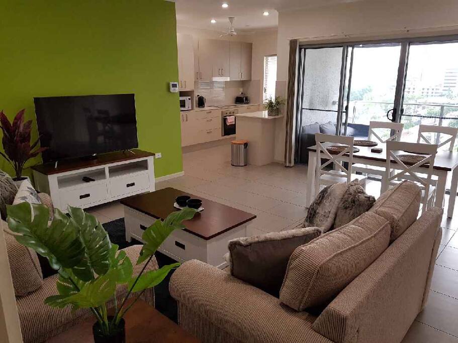 Open plan living, with balcony and a view from the top floor.